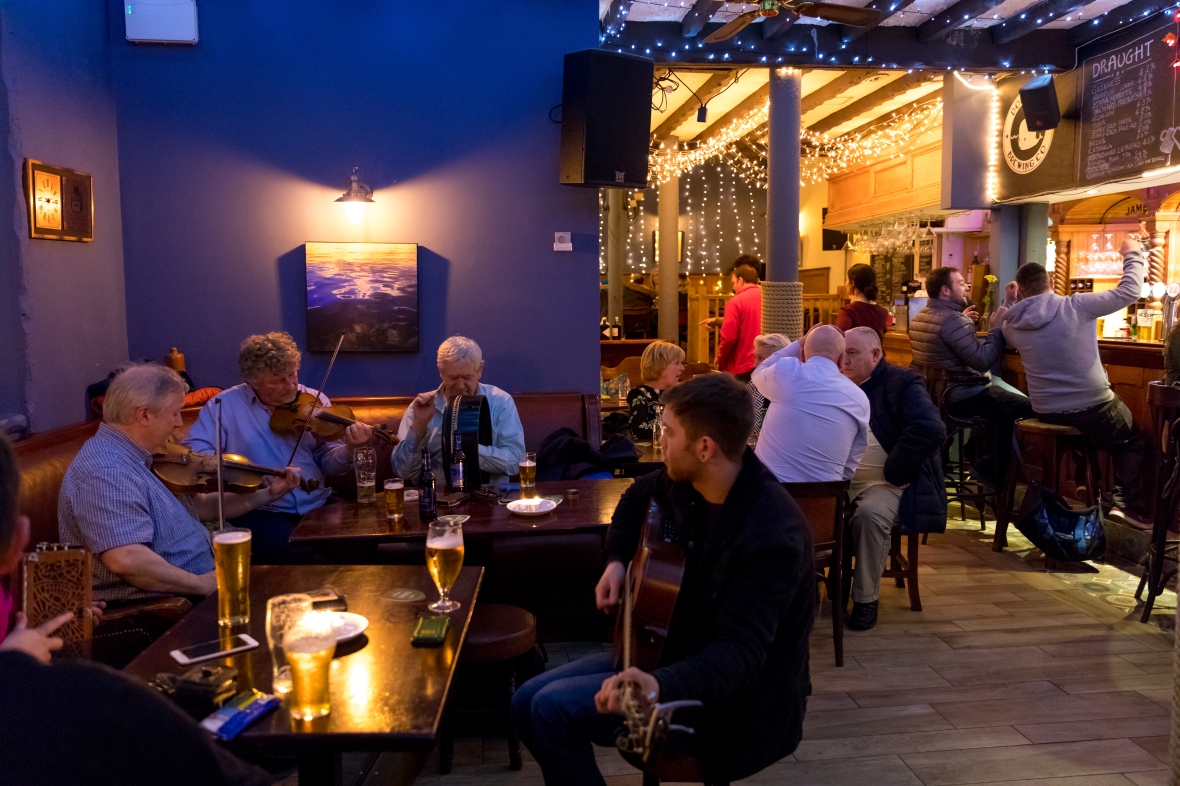 Traditional Irish Music being played by local musicians at the Guildhall Taphouse, located in the Guildhall outside the old walls in Derry, Ireland